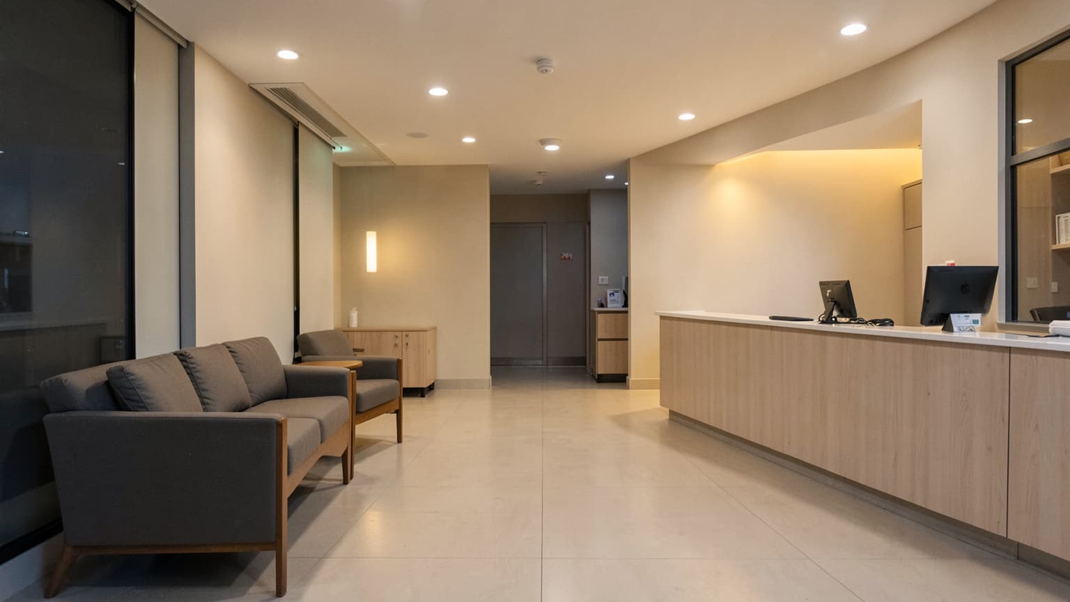 Empty, warm reception area ready for a veterinary emergency visit at night, with clean architectural lines and seating.